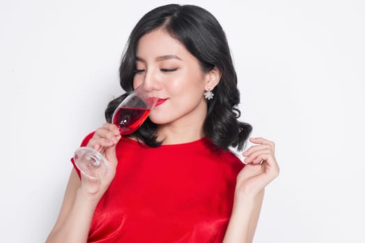 Beautiful asian girl in evening dress smiling holding glass of champagne