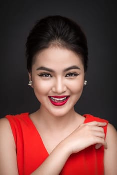Closeup of beautiful sexy girl with bright makeup and red lips. Beauty fashion asian woman.