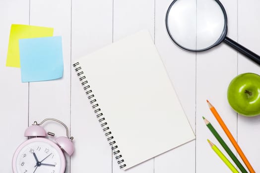 School stationery or office supplies on wood background.