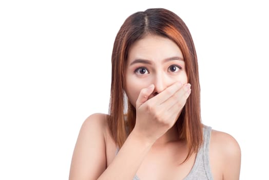 Young adult asian woman holding hand over her mouth over white background