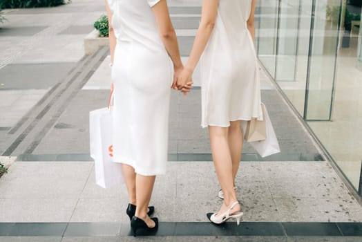 Beautiful asian girls with shopping bags walking on street at the mall