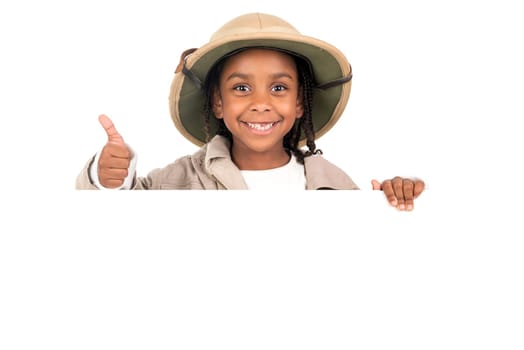 Young girl with Safari clothes behind a white board isolated in white