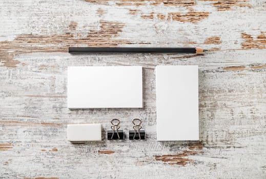 Blank stationery template for placing your design. Photo of blank branding mockup. Bank business cards, pencil, eraser, badge and sharpener. Top view.