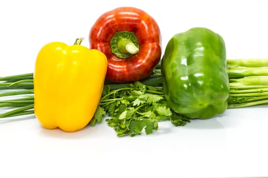 colored peppers over white background with Fresh vegetables