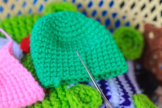 Crochet hook needle on granny square blanket, handmade art and crafts