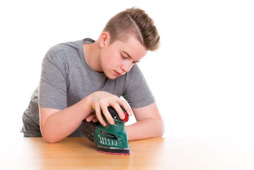 teenager in professional training using grinding machine in front of white background