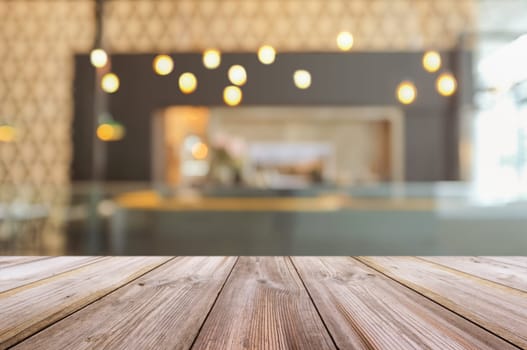 Empty wooden table top with blurred coffee shop interior background. can be used product display.
