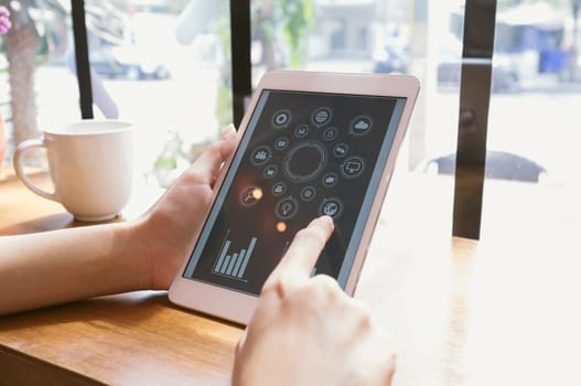 Business, office concept. Woman's hands using tablet with financial document at coffee shop.
