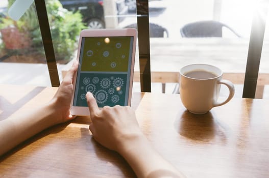 Business, office concept. Woman's hands using tablet with financial document at coffee shop.