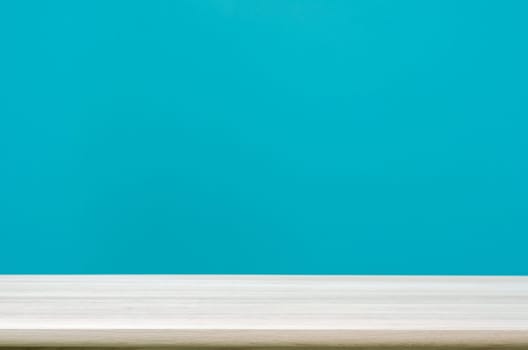 Empty wooden table top with  blue wall background. can be used product display.