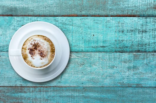 Top view cup of coffee on blue wooden table.