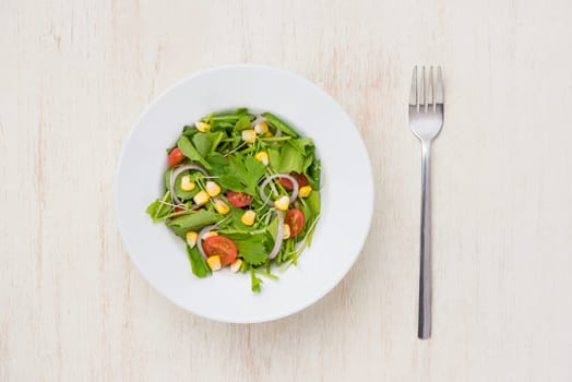 Homemade fresh green vegetable salad on table.