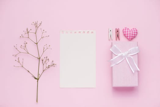 Gift box tied with pink ribbon and white flowers for mothers day
