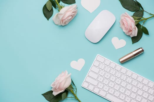 Mother's Day concept. Pink roses with gift box on woman office desk. Open notebook for copy space.