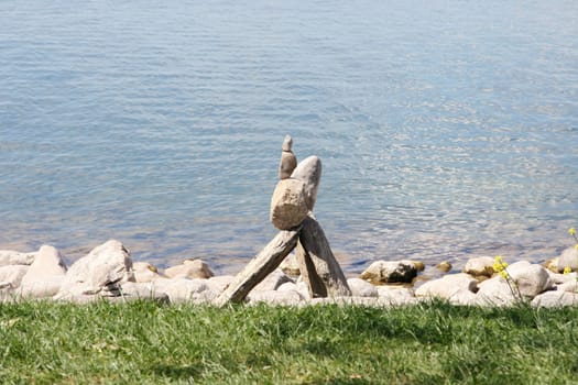 Stone stacks of natural stones,water surface in the background.