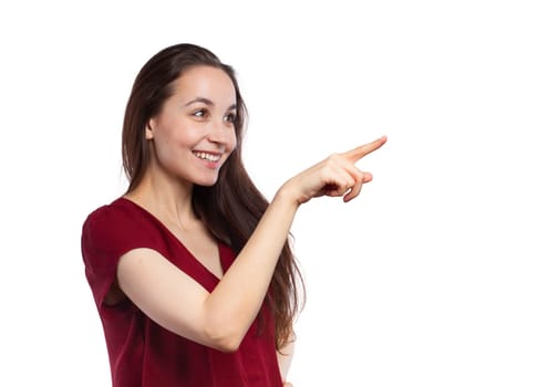 Pretty brunette pointing at copy space, isolated on white