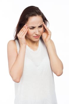 Beautiful woman suffering of a headache and massaging her temples, isolated on white