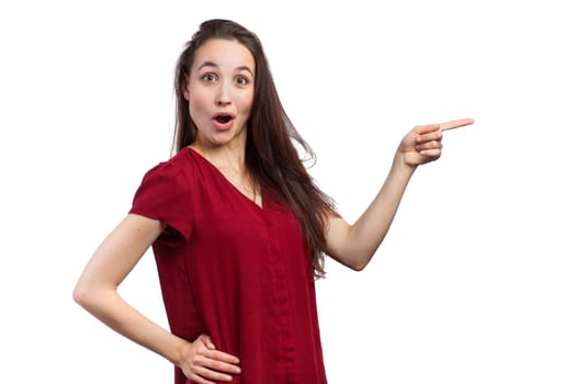 Funny woman pointing at copy space, isolated on white