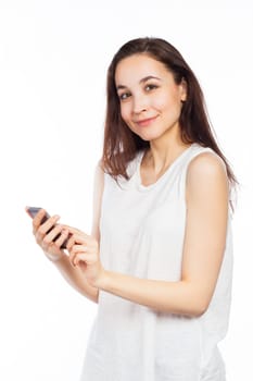 Young woman using a phone and looking at the camera, isolated on white