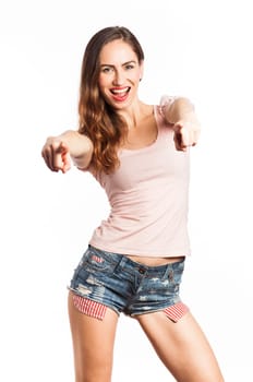 Portrait of an attractive woman pointing at the camera, isolated on white