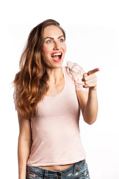 Portrait of a surprised and happy woman pointing at the copy space, isolated on white