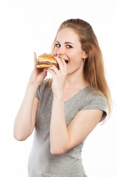 Portrait of a cute young woman with a big burger, isolated on white