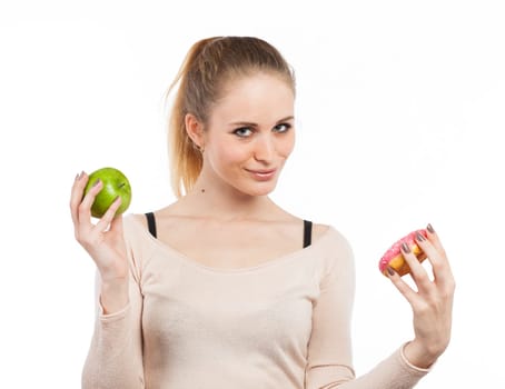 Portrait of a cute girl with a green apple and a donut, isolated on white