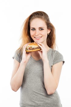 Portrait of a cute young woman with a big burger, isolated on white