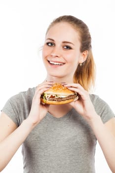 Portrait of a cute young woman holding a burger, isolated on white
