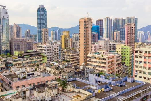 Old houses surrounded modern skyscrapers in Hong Kong. Hong Kong is popular tourist destination of Asia and leading financial centre of the world.