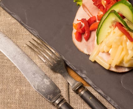 Danish specialties and national dishes, high-quality open sandwich. Sandwich with sliced ham, Mayonnaise Pickled peppers, asparagus and cucumbers served on a plate ready for eating