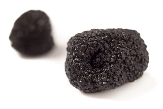 Delicate exclusive black truffles, isolated on white background