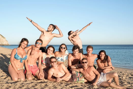 Group of happy teenage friends at the beach