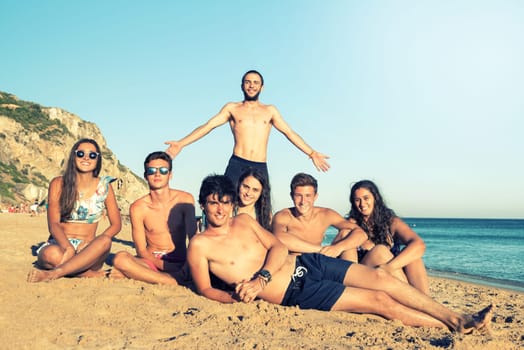 Group of happy teenage friends having fun at the beach