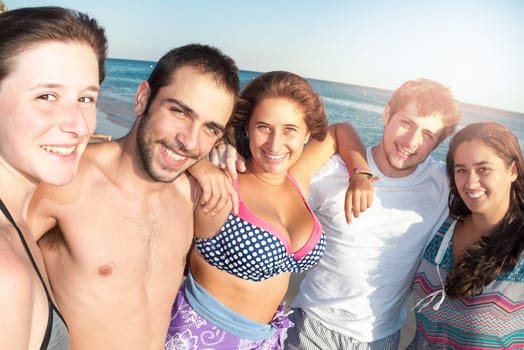 Group of happy teenage friends at the beach