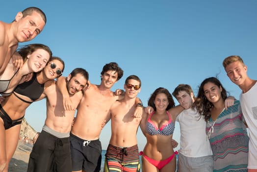Group of happy teenage friends at the beach