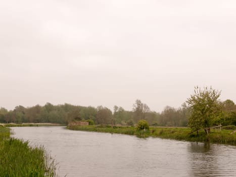 a lovely river running through a park in the uk in spring