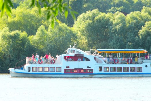 landscape with promenade motor ship with passengers on Desna river near Chernihiv