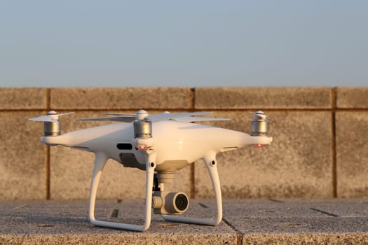 KAGAWA, JAPAN - APRIL 29, 2017: White drone Dji Phantom4Pro stay on concrete brick and ready to fly