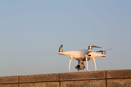KAGAWA, JAPAN - APRIL 29, 2017: White drone Dji Phantom4Pro stay on concrete brick and ready to fly