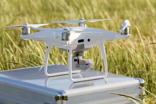 KAGAWA, JAPAN - APRIL 23, 2017: White drone Dji Phantom4Pro stay on metal bag and ready to fly.