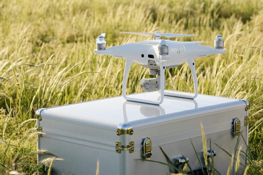 KAGAWA, JAPAN - APRIL 23, 2017: White drone Dji Phantom4Pro stay on metal bag and ready to fly.