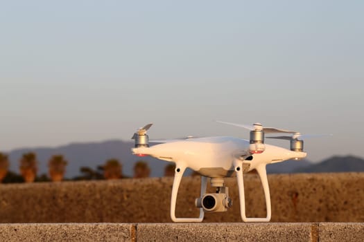 KAGAWA, JAPAN - APRIL 29, 2017: White drone Dji Phantom4Pro stay on concrete brick and ready to fly