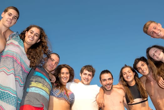 Group of happy teenage friends having fun at the beach