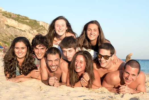 Group of happy teenage friends at the beach