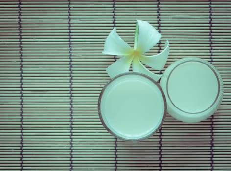 Fresh Soy milk (Soya milk) on bamboo place mat with white plumeria flower. Retro-Vintage filter effect