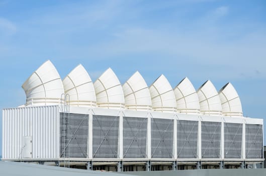 Industrial cooling towers or air cooled chillers on building rooftop