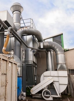 Industrial factory air filtration system. Tubes, tank and chimney.