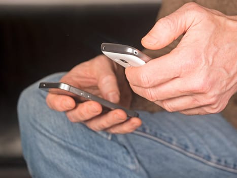 Hands hold two smartphones