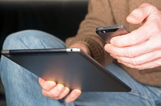 Holding hands tablet and smartphone